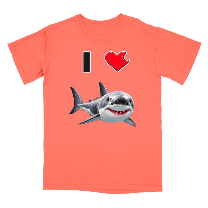 A coral pink short-sleeve t-shirt with a graphic print of a shark and the text 'I' and a heart, displayed on a solid white background.