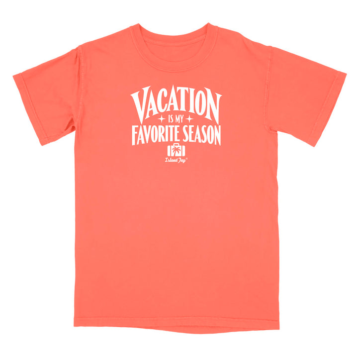 A coral orange short-sleeve t-shirt with a white graphic print on the front that reads 'VACATION IS MY FAVORITE SEASON' with a small camera icon and 'Lalique Dog' branding underneath, displayed on a solid white background.