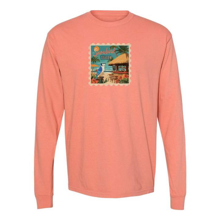 Coral long-sleeve shirt with a beach graphic on a white background