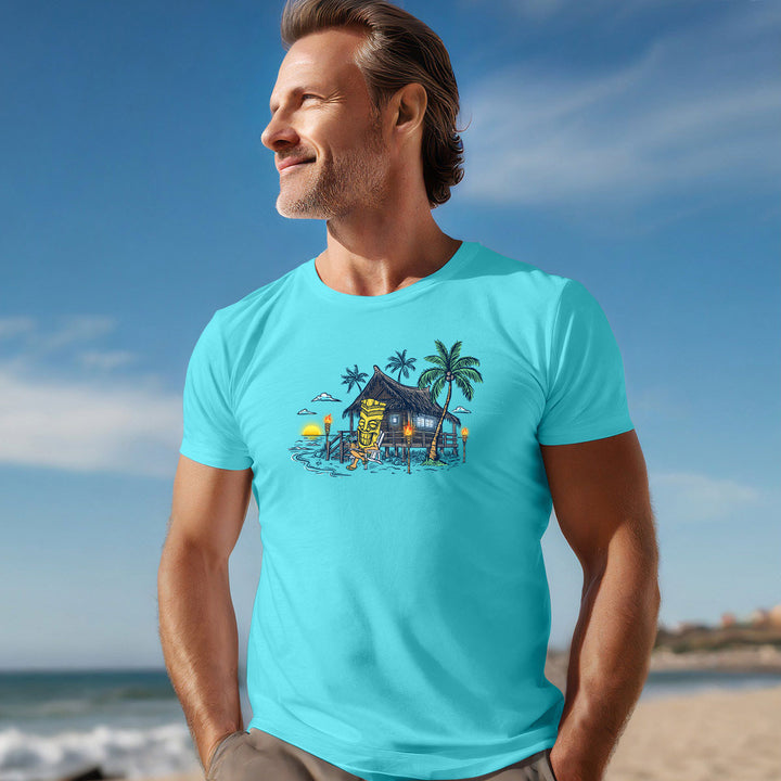 Model image of a man at a beach wearing Tiki's Breezy Bungalow T-Shirt in Lagoon Blue
