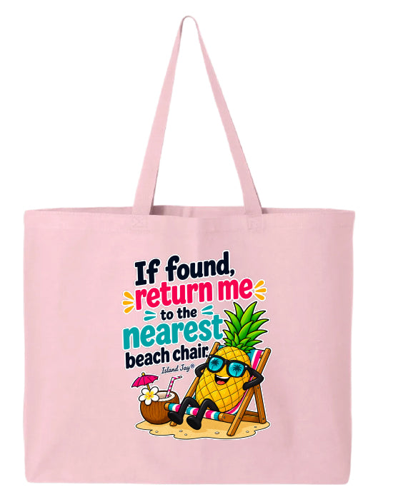 A light pink canvas tote bag with long handles, featuring a colorful graphic print of a pineapple character wearing sunglasses and reclining in a beach chair next to a coconut drink, with the text 'If found, return me to the nearest beach chair. Island Style.