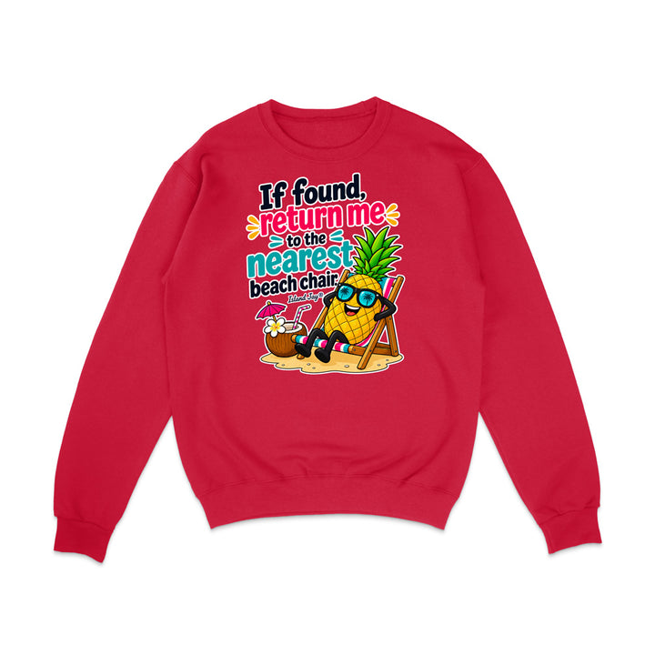 A red crewneck sweatshirt featuring a colorful graphic of a pineapple character wearing sunglasses and a beach chair next to a coconut drink, with the text 'If found, return me to the nearest beach chair'.