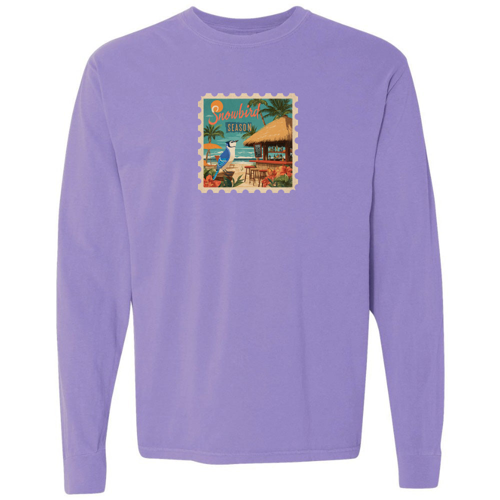 Purple long-sleeve shirt with a tropical graphic on a white background