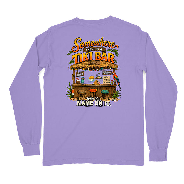 A light purple long-sleeve t-shirt shown from the back, featuring a colorful graphic of a tropical 'Tiki Bar' with the text 'Somewhere THERE IS A TIKI BAR' and 'With My NAME ON IT.'.