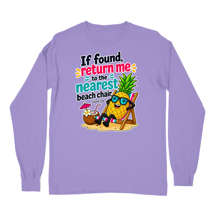 A light purple long-sleeve t-shirt with a colorful graphic print on the front. The graphic features a cartoon pineapple wearing sunglasses and reclining in a beach chair next to a coconut drink, with the text 'If found, return me to the nearest beach chair' and 'Florida Day'.