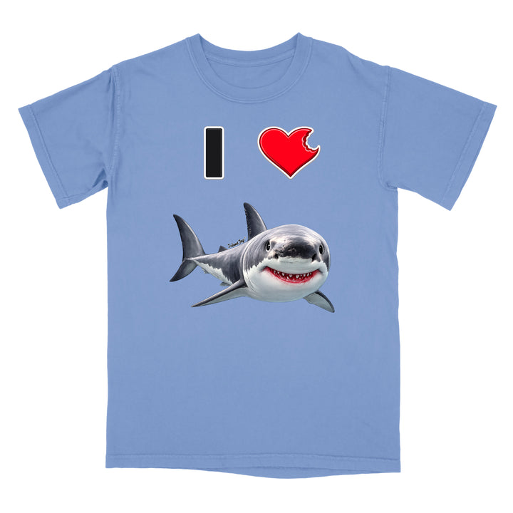 A light blue short-sleeve crewneck t-shirt featuring a graphic print of a great white shark and the text 'I' followed by a red heart and the shark, displayed on a solid white background.