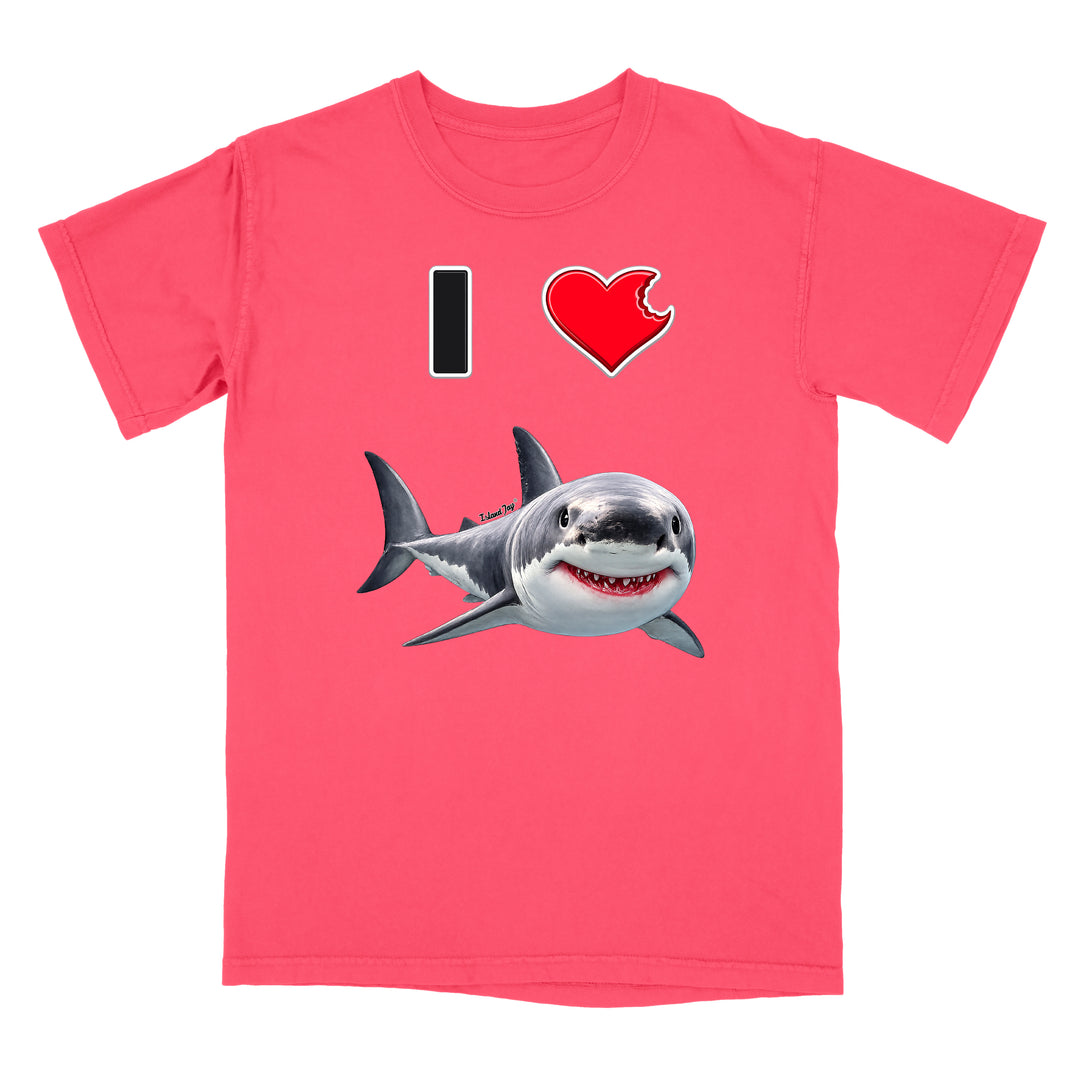 A pink short-sleeve crewneck t-shirt featuring a graphic print of a great white shark below a black 'I' and a red heart with a bite taken out of it, on a solid white background.