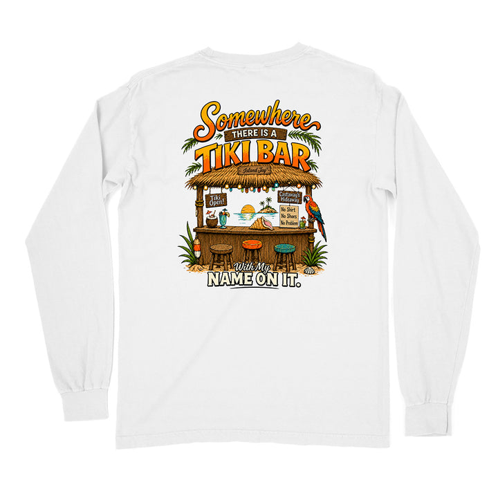 A white long-sleeve t-shirt shown from the back, featuring a colorful graphic print of a tropical tiki bar with the text 'Somewhere There Is A Tiki Bar' and 'With My NAME ON IT.'.