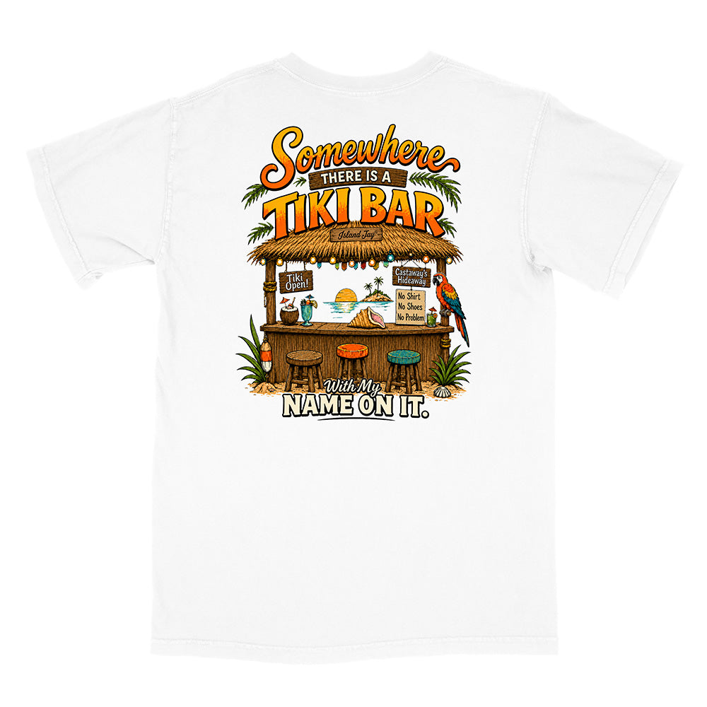 A white short-sleeve t-shirt with a colorful graphic print on the back featuring a tiki bar, parrots, and the text 'Somewhere THERE IS A TIKI BAR With My NAME ON IT.'.