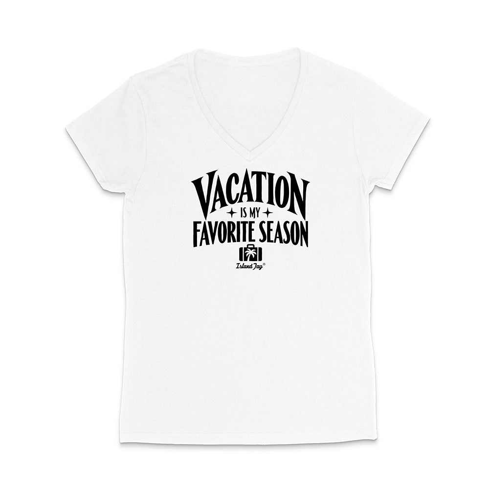 A white women's V-neck short-sleeve t-shirt with a black graphic print on the front that reads 'VACATION IS MY FAVORITE SEASON' with a small camera icon and 'Dakota Joy' brand logo underneath, displayed on a clean white background.