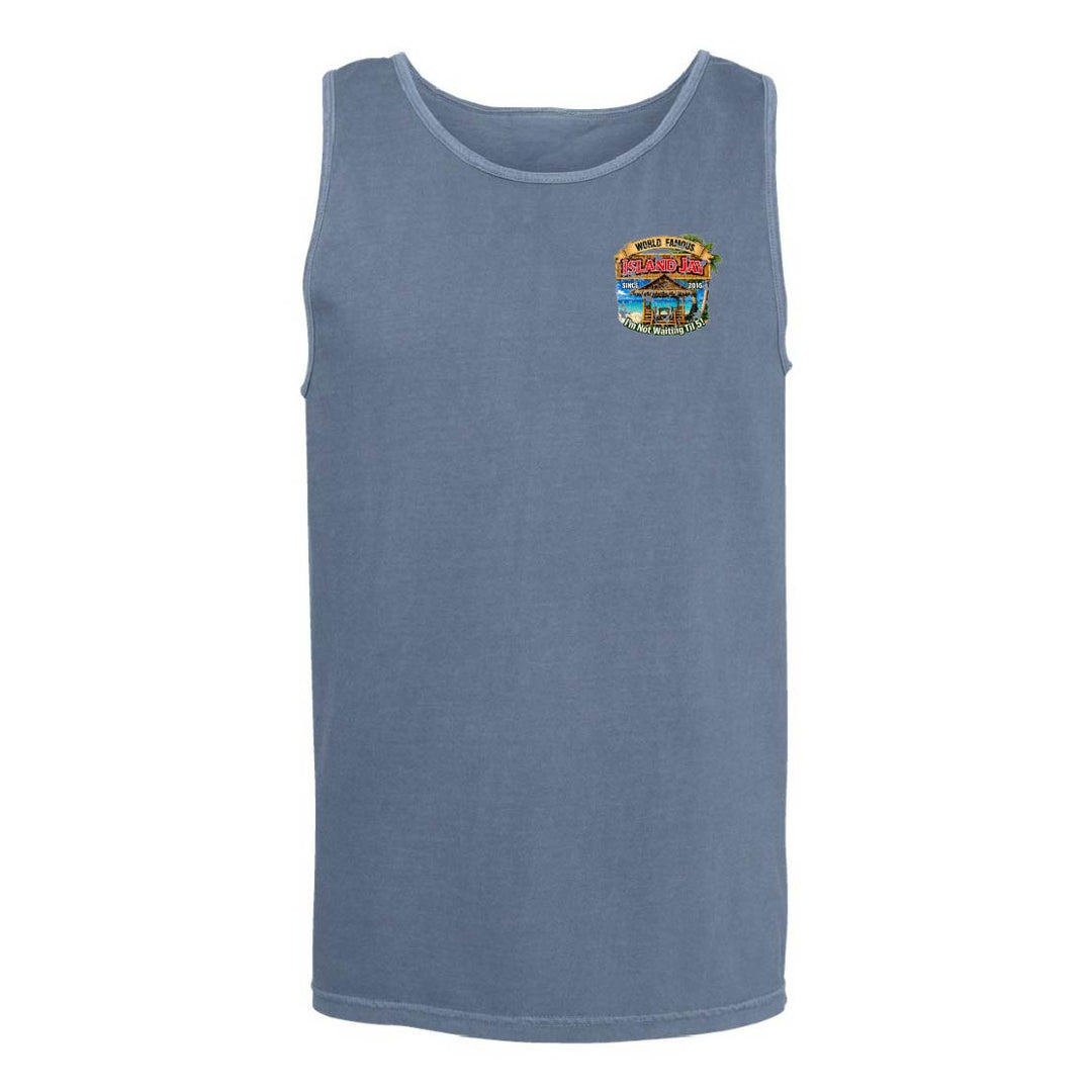 A sleeveless tank top in a washed slate blue color, featuring a small colorful graphic print on the left chest depicting a tropical beach scene with the text 'Tropical Paradise'.