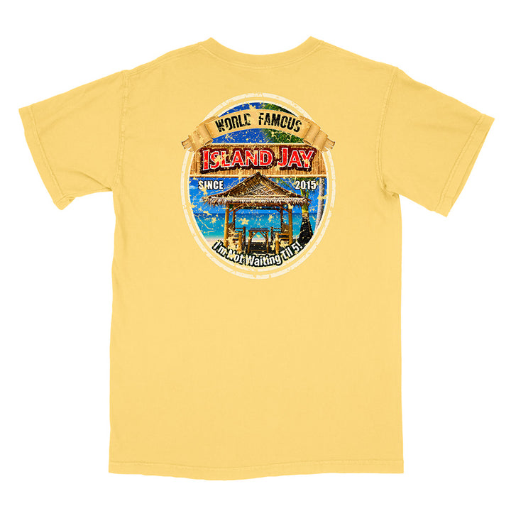 A yellow short-sleeve t-shirt shown from the back, featuring a large circular graphic print on the upper back with a beach bar scene and the text 'World Famous Island Jay' and 'Hana Waioa Beach'.