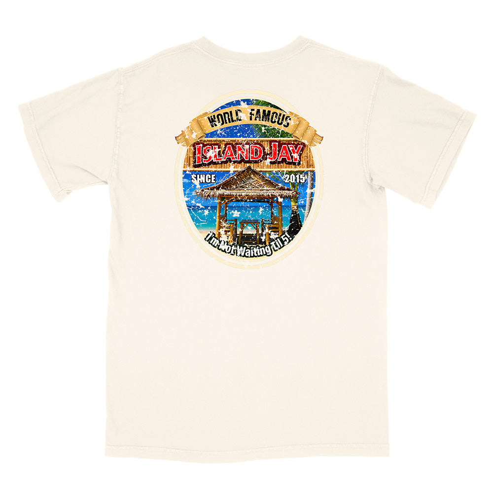 An off-white short-sleeve t-shirt with a large circular graphic print on the back. The graphic features a tropical beach scene with a gazebo, blue water, and text reading 'WORLD FAMOUS ISLAND JAY' and 'HONOLULU WAIKAI ISLAND'.