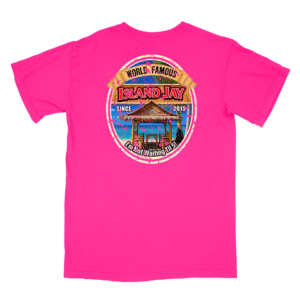 A bright pink short-sleeve t-shirt with a circular graphic print on the front. The graphic features a tropical island hula dancer scene with the text 'WORLD FAMOUS ISLAND JAY' and 'I'm Not Waiting For You'.