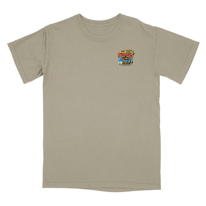 A short-sleeve crewneck t-shirt in a light khaki-beige color, featuring a small colorful graphic on the left chest depicting a beach scene with the text 'The Beach Bar'.