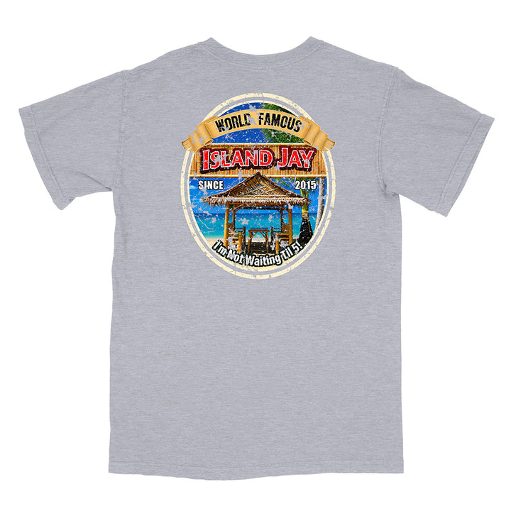 A heather gray short-sleeve t-shirt shown from the back, featuring a large circular graphic print on the center back with a beach cabana, blue water, and text reading 'World Famous Island Jay' and 'The Best Waiting Spot.'.