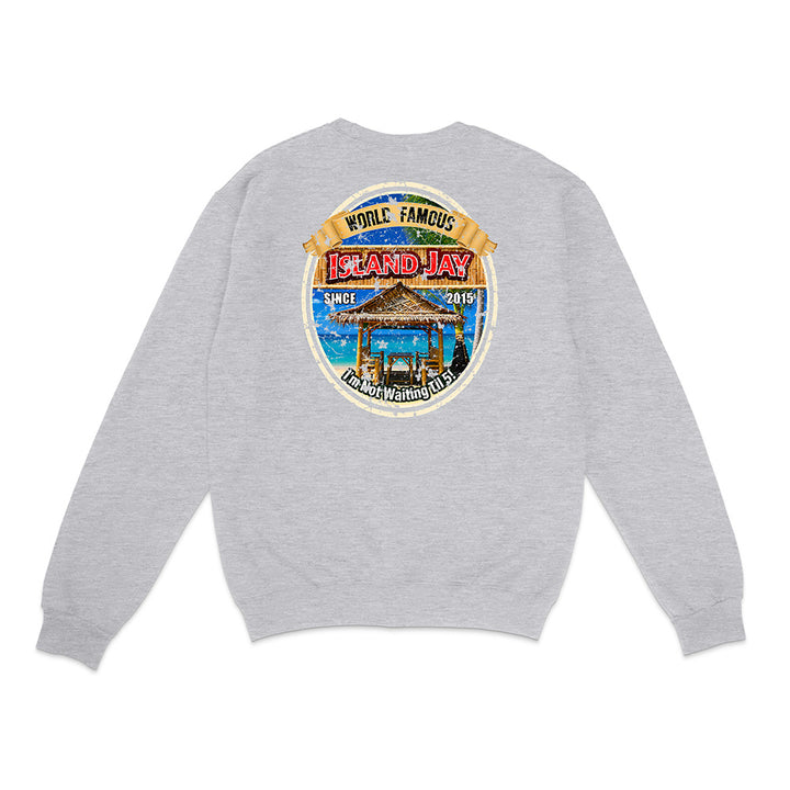 A light gray heather crewneck sweatshirt shown from the back, featuring a large circular graphic print on the upper back with a beach scene and the text 'Whale Famous Island Hay'.