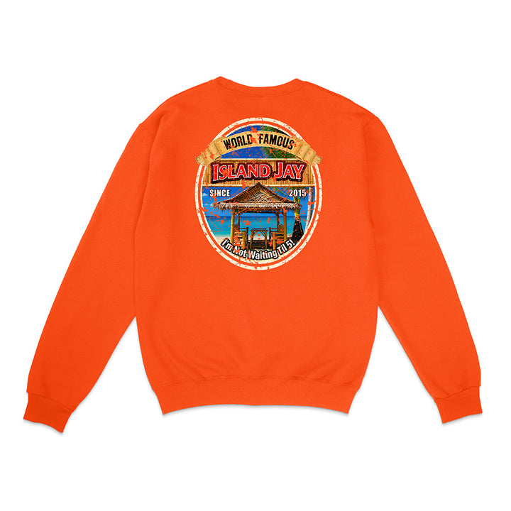 An orange crewneck sweatshirt shown from the back, featuring a large circular graphic print on the center back with a beach scene and the text 'ISLAND HAY'.