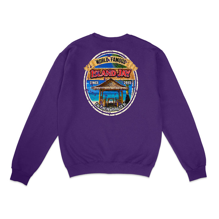 A purple crewneck sweatshirt shown from the back, featuring a large circular graphic print on the center back with a beach cabana illustration and the text 'World Famous Island Jay' and 'LPGA Champions'.