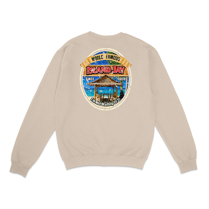 A light beige crewneck sweatshirt shown from the back, featuring a large circular graphic print on the upper back with a beach scene and the text 'WHILE FAMOUS Island Hay'.