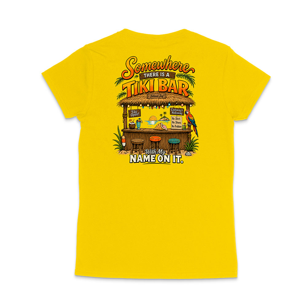 A bright yellow short-sleeve t-shirt shown from the back, featuring a colorful graphic of a tropical 'Tiki Bar' with a parrot and the text 'Somewhere THERE IS A TIKI BAR With My NAME ON IT.'.