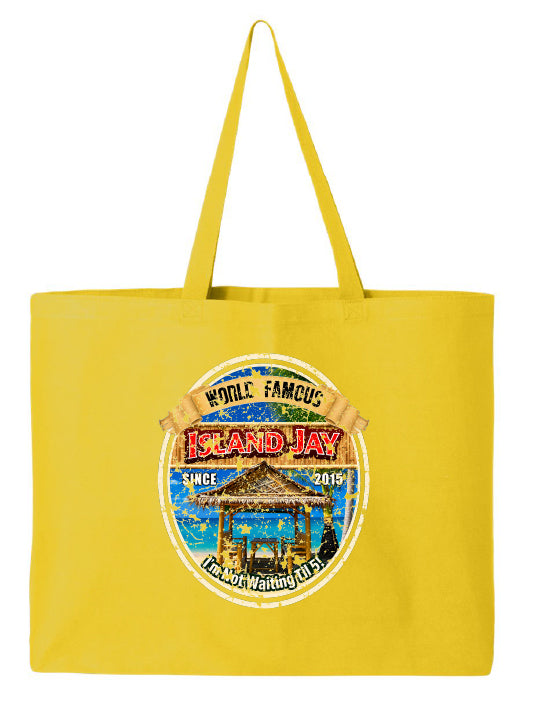 A bright yellow canvas tote bag with two shoulder straps, featuring a circular graphic print on the front that reads 'Whale Famous Island Jay' with a tropical pavilion illustration.