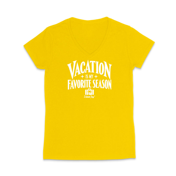 A bright yellow women's V-neck short-sleeve t-shirt with a white graphic print on the front that reads 'VACATION IS MY FAVORITE SEASON' with a small 'Island Trip' logo underneath, displayed on a clean white background.