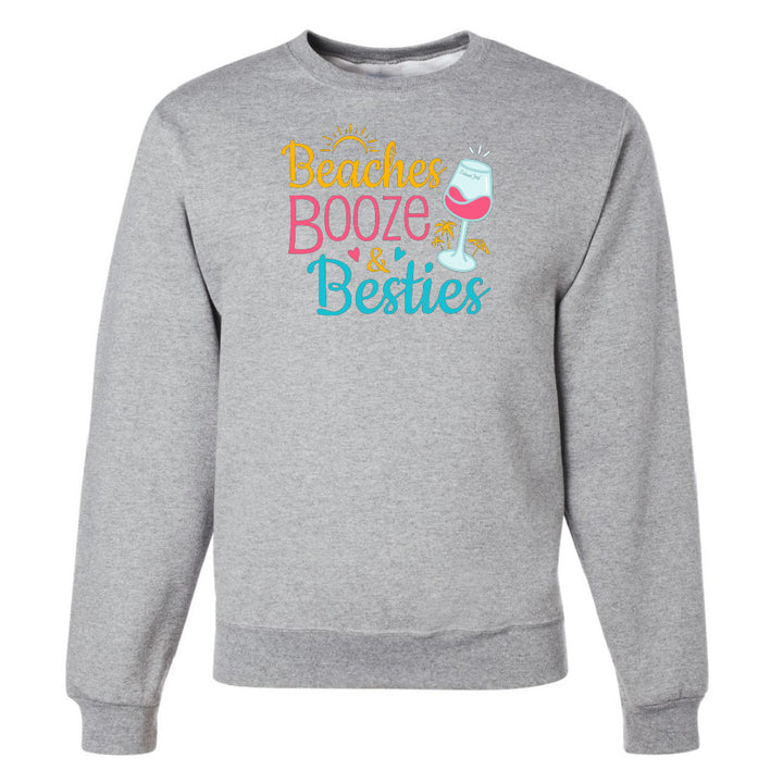 Gray sweatshirt with 'Beaches Booze & Besties' text and wine glass graphic on a white background
