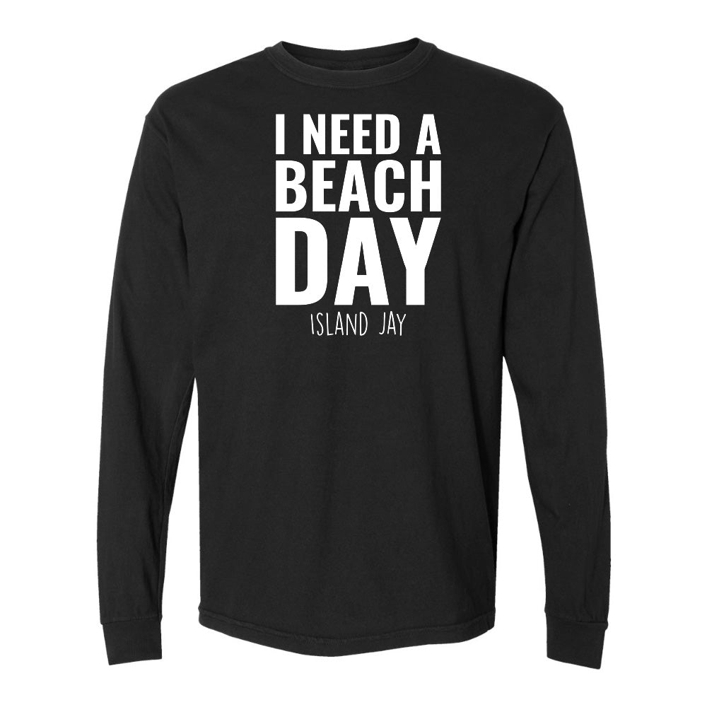 Black long-sleeve shirt with 'I Need a Beach Day' text on a white background