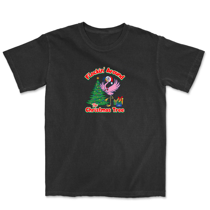 Black t-shirt with a festive design featuring a flamingo and Christmas tree on a white background