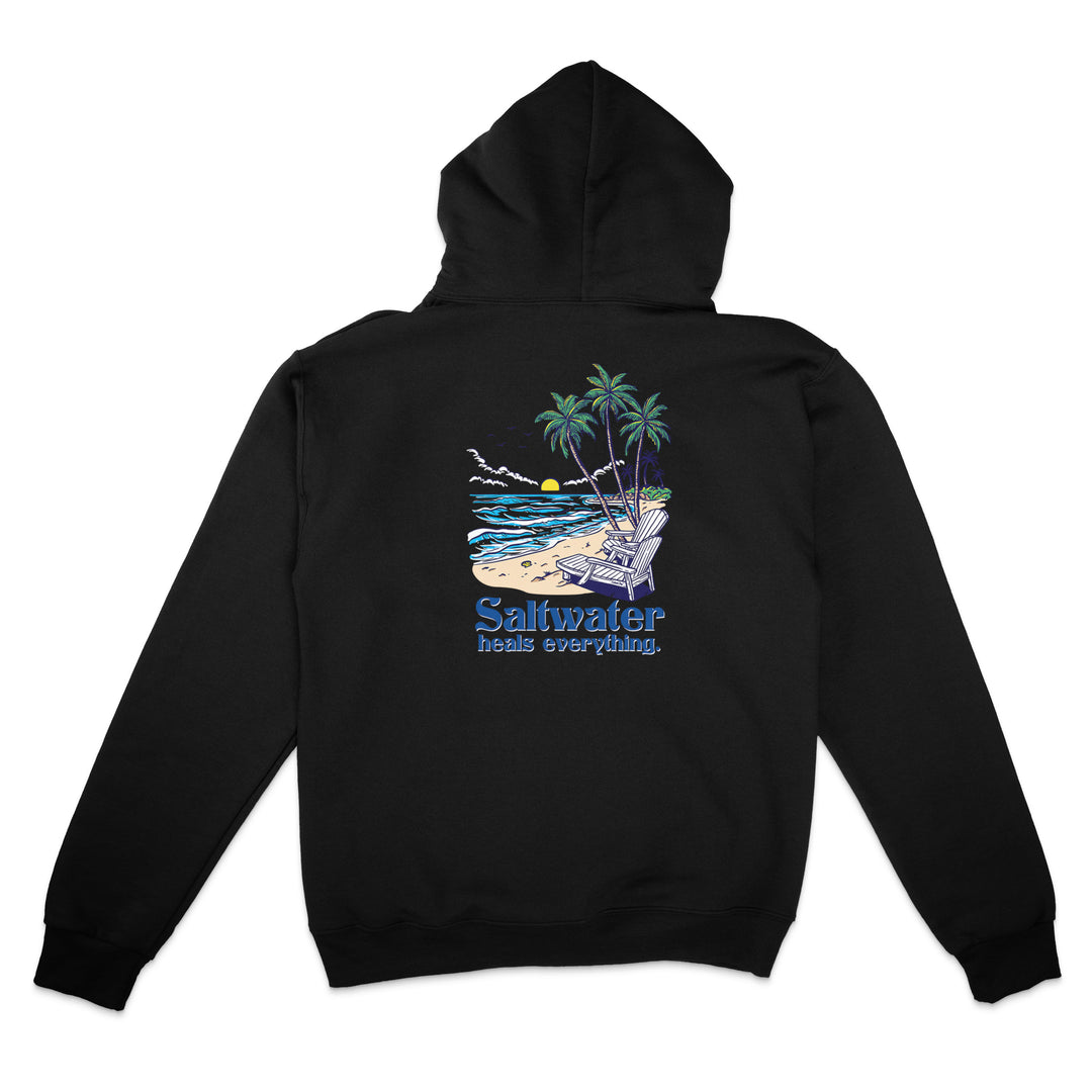 Black hoodie with a beach scene graphic and 'Saltwater needs everything' text on the back, on a white background.