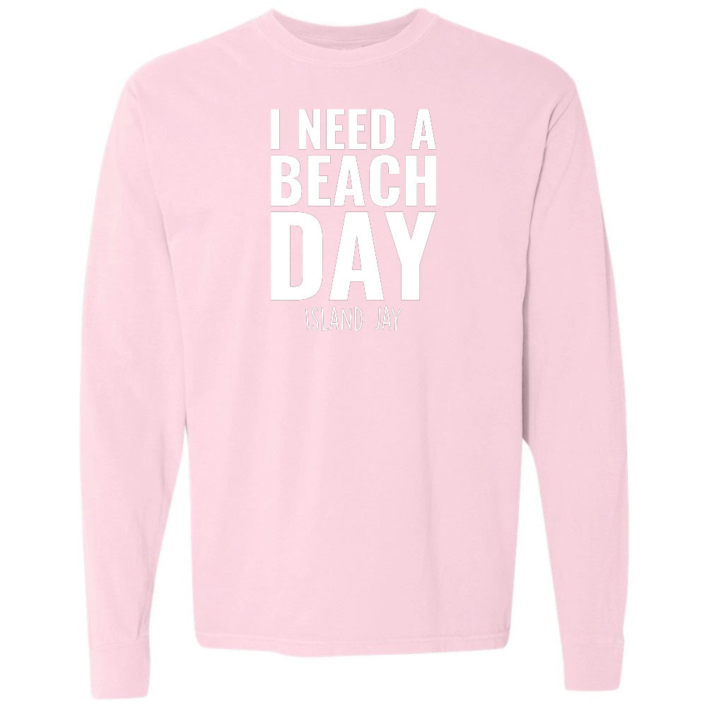 Pink sweatshirt with 'I NEED A BEACH DAY' text on a white background