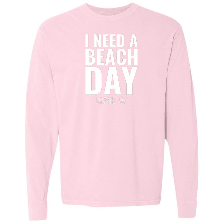 Pink sweatshirt with 'I NEED A BEACH DAY' text on a white background