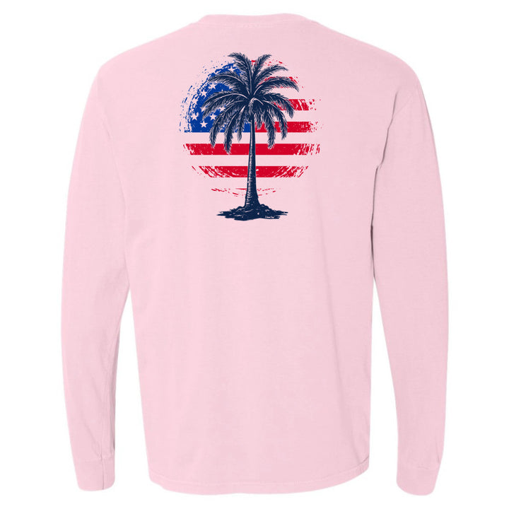 Pink long-sleeve shirt with a palm tree design on an American flag background.