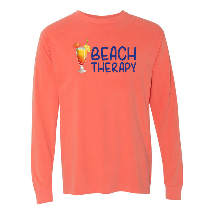 Coral long-sleeve shirt with 'Beach Therapy' text and cocktail graphic on a white background