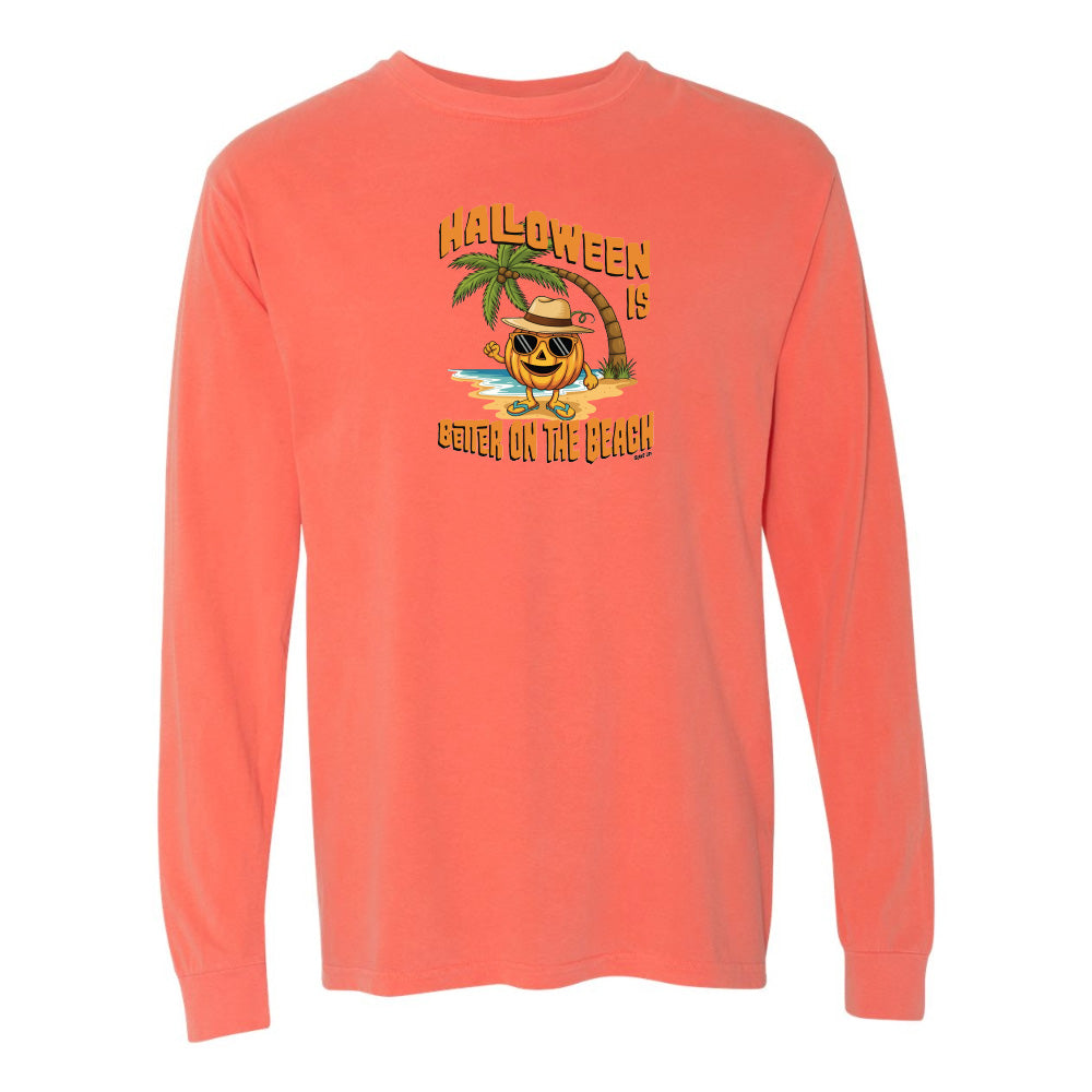 Coral long-sleeve shirt with Halloween design featuring a pumpkin on a beach.