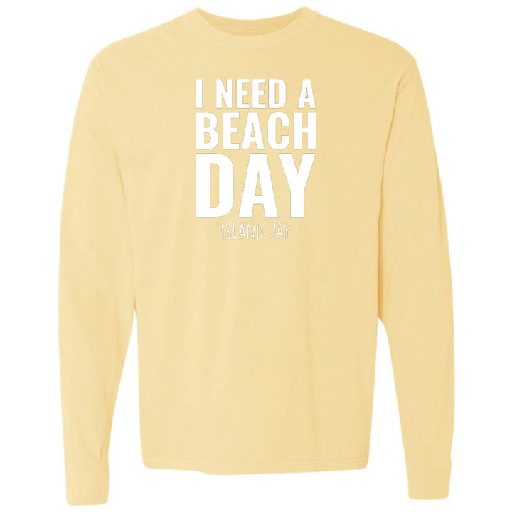 Yellow sweatshirt with 'I NEED A BEACH DAY' text on a white background