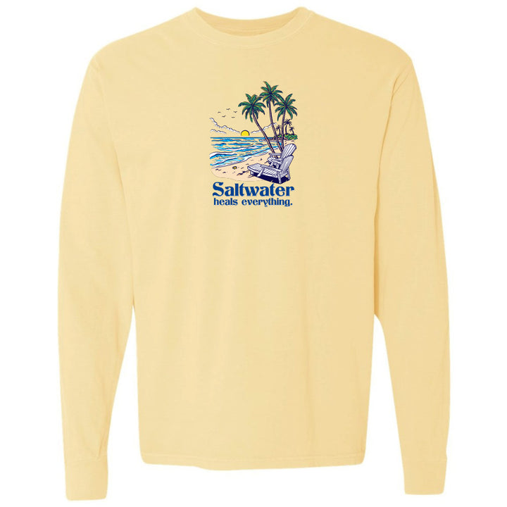 Yellow long-sleeve shirt with a beach graphic and 'Saltwater heals everything' text on a white background