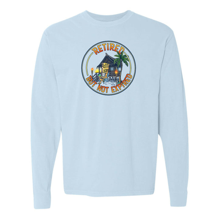 Light blue long-sleeve shirt with a tropical hut graphic and text on a white background