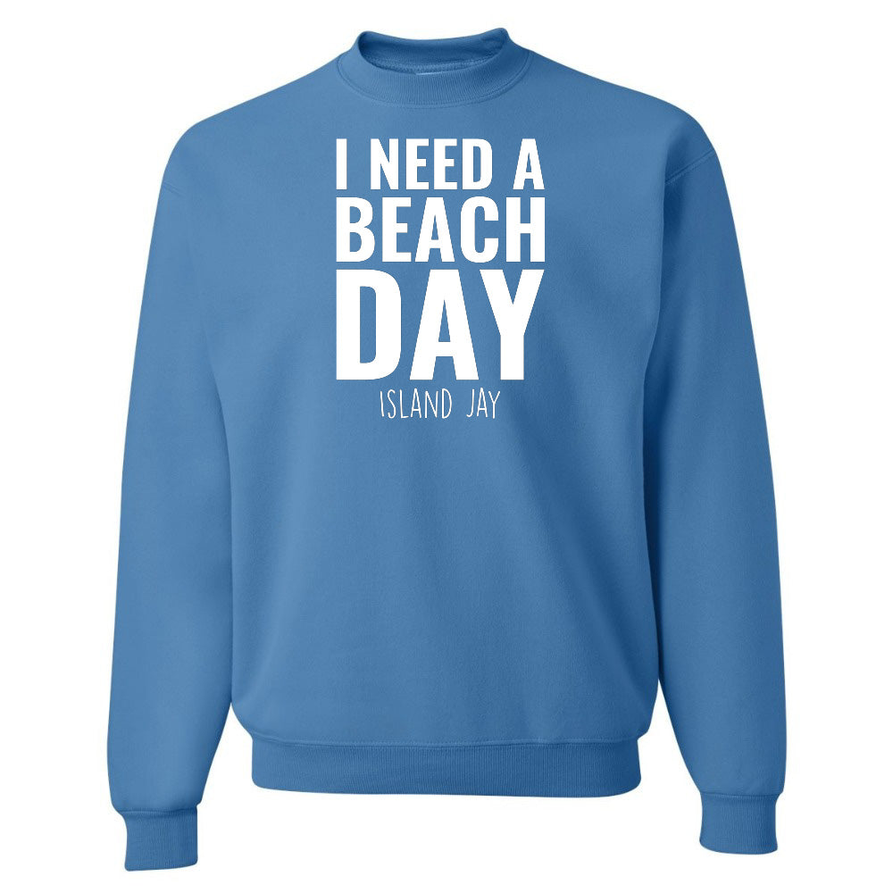 Blue sweatshirt with 'I NEED A BEACH DAY' text on a white background