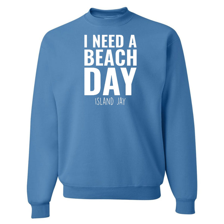 Blue sweatshirt with 'I NEED A BEACH DAY' text on a white background