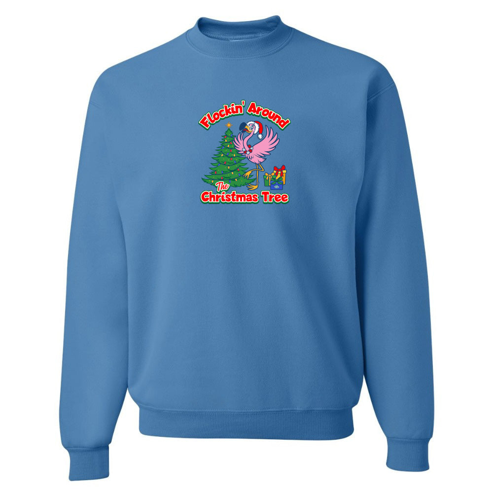 Blue sweatshirt with Christmas-themed design featuring a flamingo and tree on a white background