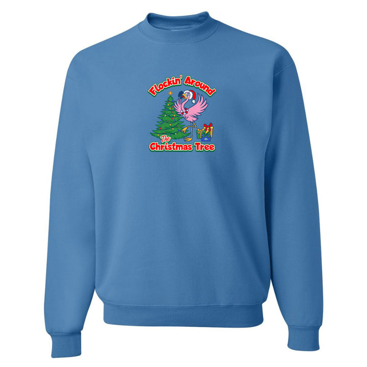 Blue sweatshirt with Christmas-themed design featuring a flamingo and tree on a white background