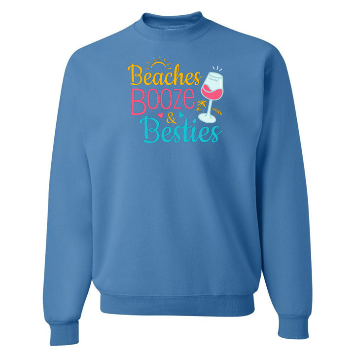Blue sweatshirt with 'Beaches Booze & Besties' text and wine glass graphic on a white background