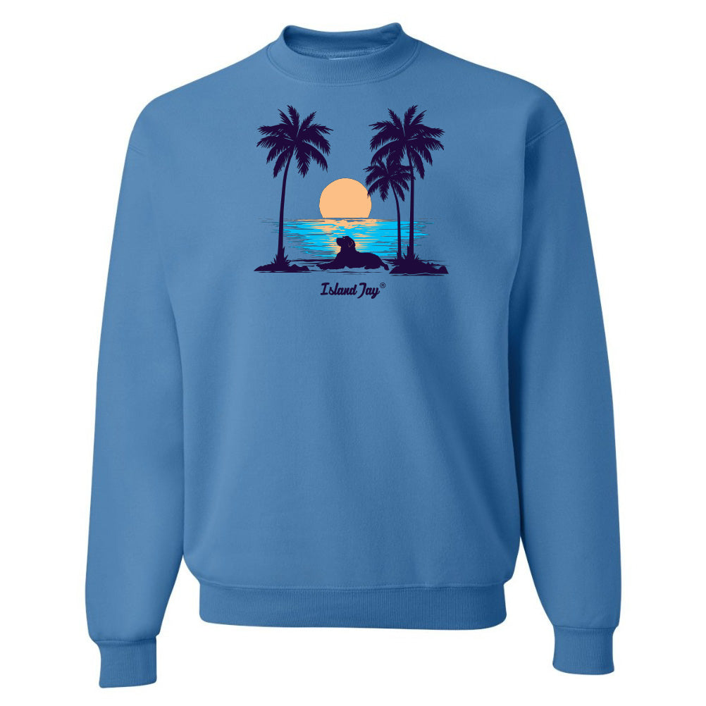 Blue sweatshirt with a tropical design featuring palm trees and a sunset.