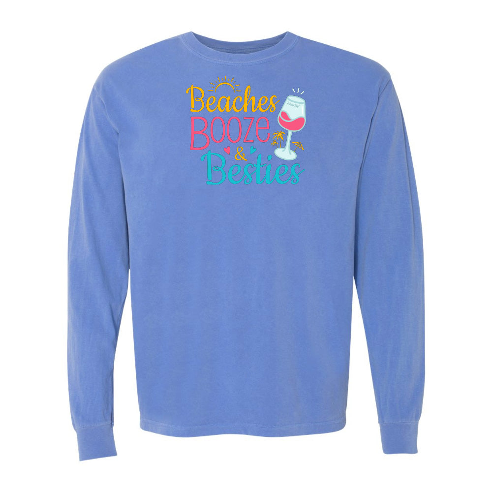 Blue long-sleeve shirt with 'Beaches Booze & Besties' text and wine glass graphic on a white background
