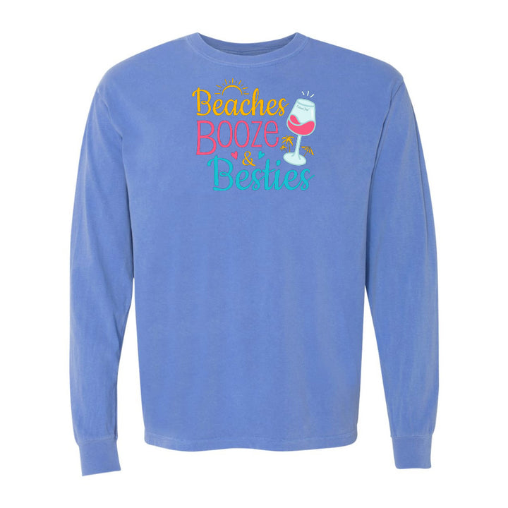 Blue long-sleeve shirt with 'Beaches Booze & Besties' text and wine glass graphic on a white background