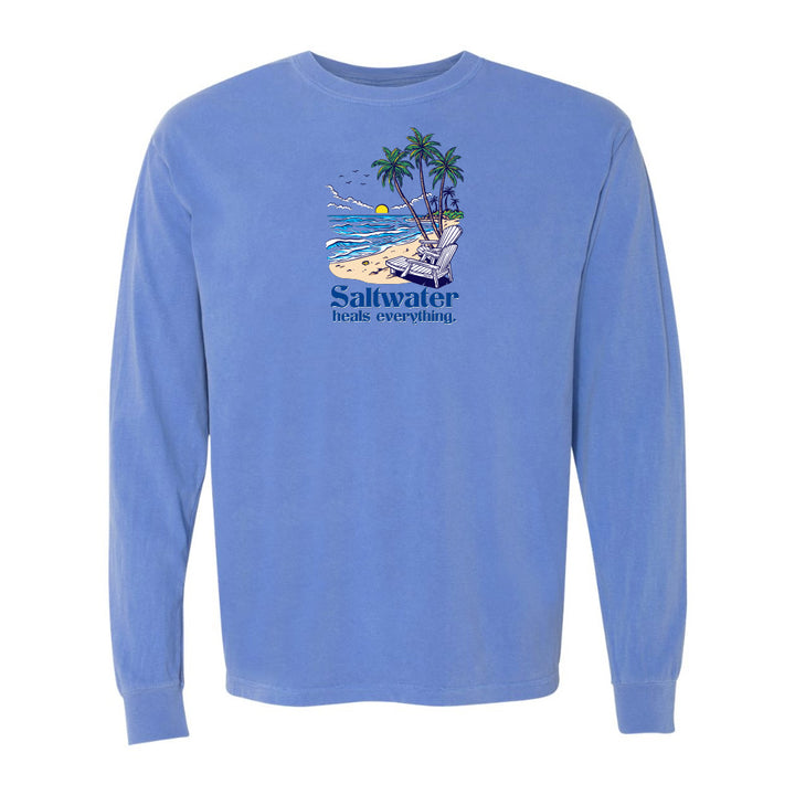 Blue long-sleeve shirt with a beach graphic and 'Saltwater heals everything' text on a white background