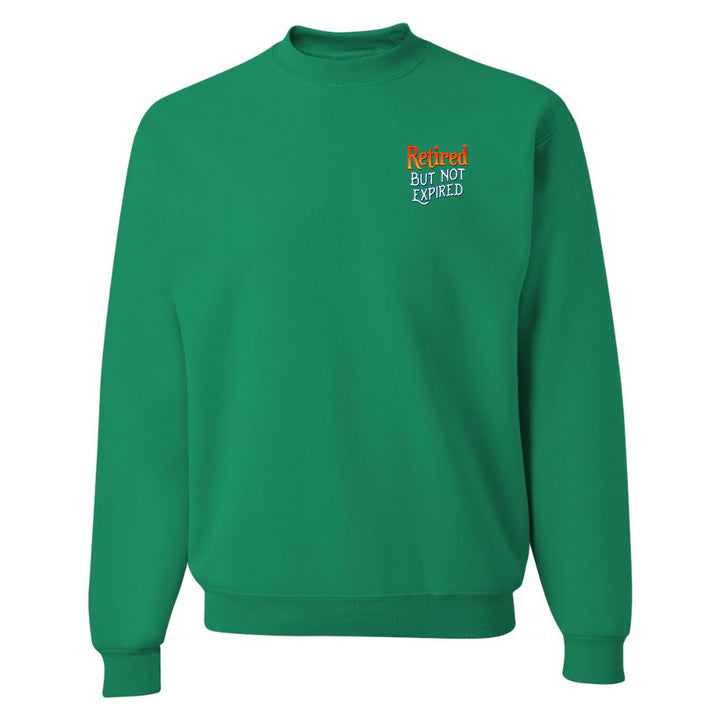 Green sweatshirt with text 'Retired But Not Expired' on a white background