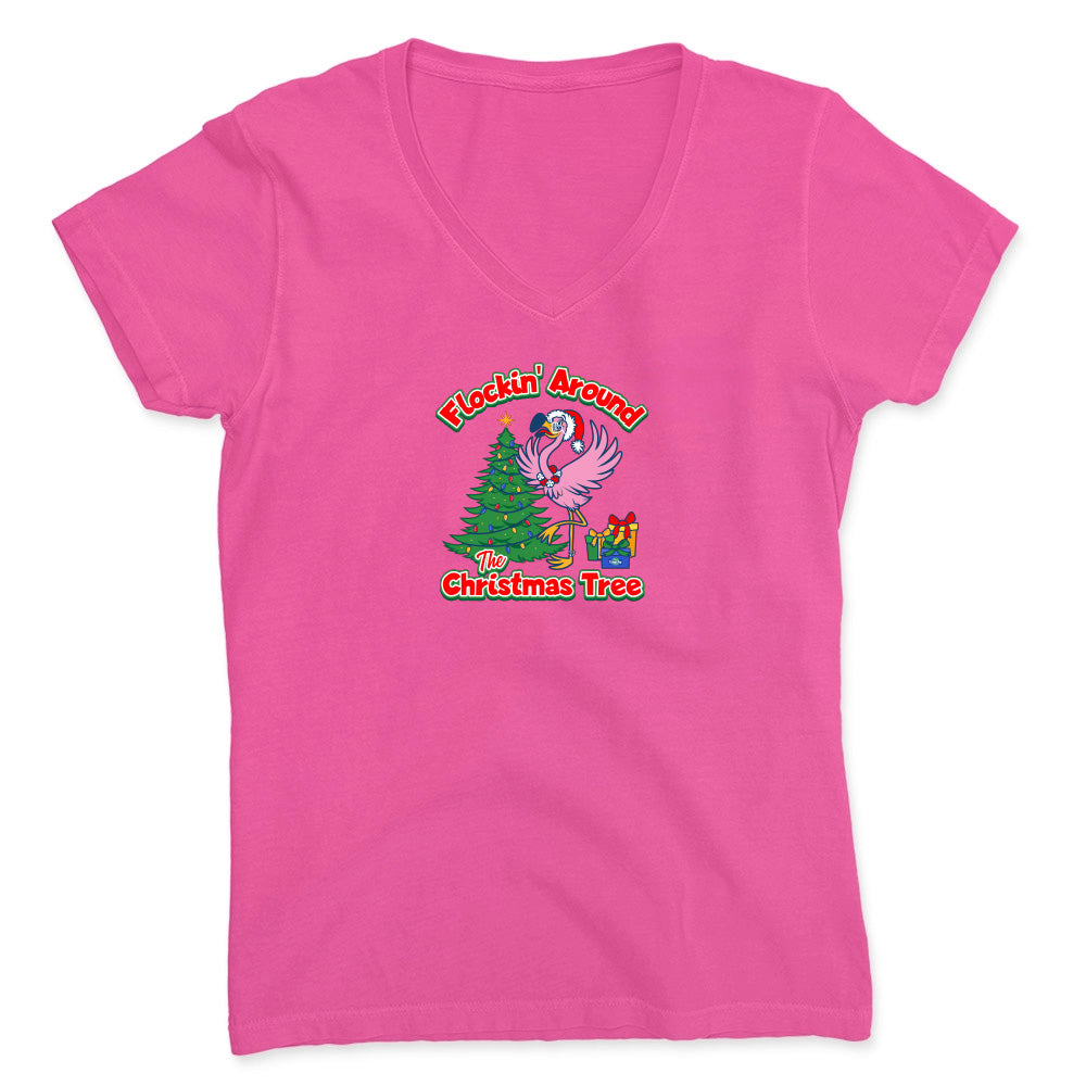 Pink t-shirt with a Christmas-themed graphic featuring a flamingo and tree on a white background